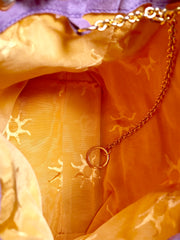Vintage Christian Lacroix purple suede leather hobo bucket shoulder bag with drawstrings and golden sun, heart etc.. motifs. Unique and chic.