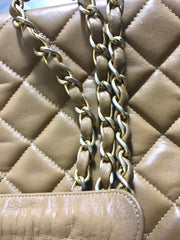 80's Vintage CHANEL brown lambskin large classic bag with double golden chain strap and a CC pull charm.