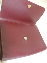 Vintage Cartier wine leather clutch bag, mini document purse with logo motif. Unisex bag from must de Cartier Collection.