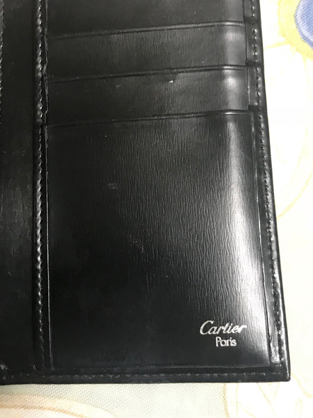 CARTIER Paris. Black leather wallet, signed. Dim: 17 x 9…