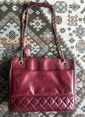 Vintage CHANEL wine leather tote bag with gold chain handles and CC motif charm. Classic purse.