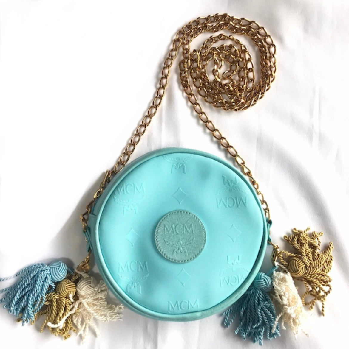 MINT. Vintage MCM blue monogram mini Suzy Wong pouch bag with golden chain and blue, gold, and white fringes. Michael Cromer. 0404041