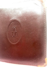 Vintage Cartier, must de Cartier wine leather square wallet with gold tone frames. Unisex use.