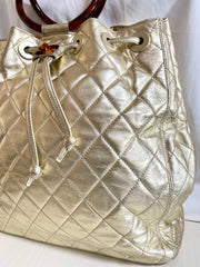 Vintage CHANEL campaign gold lamb leather hobo bucket bag with marble hoop handles and turn lock CC. 0412081