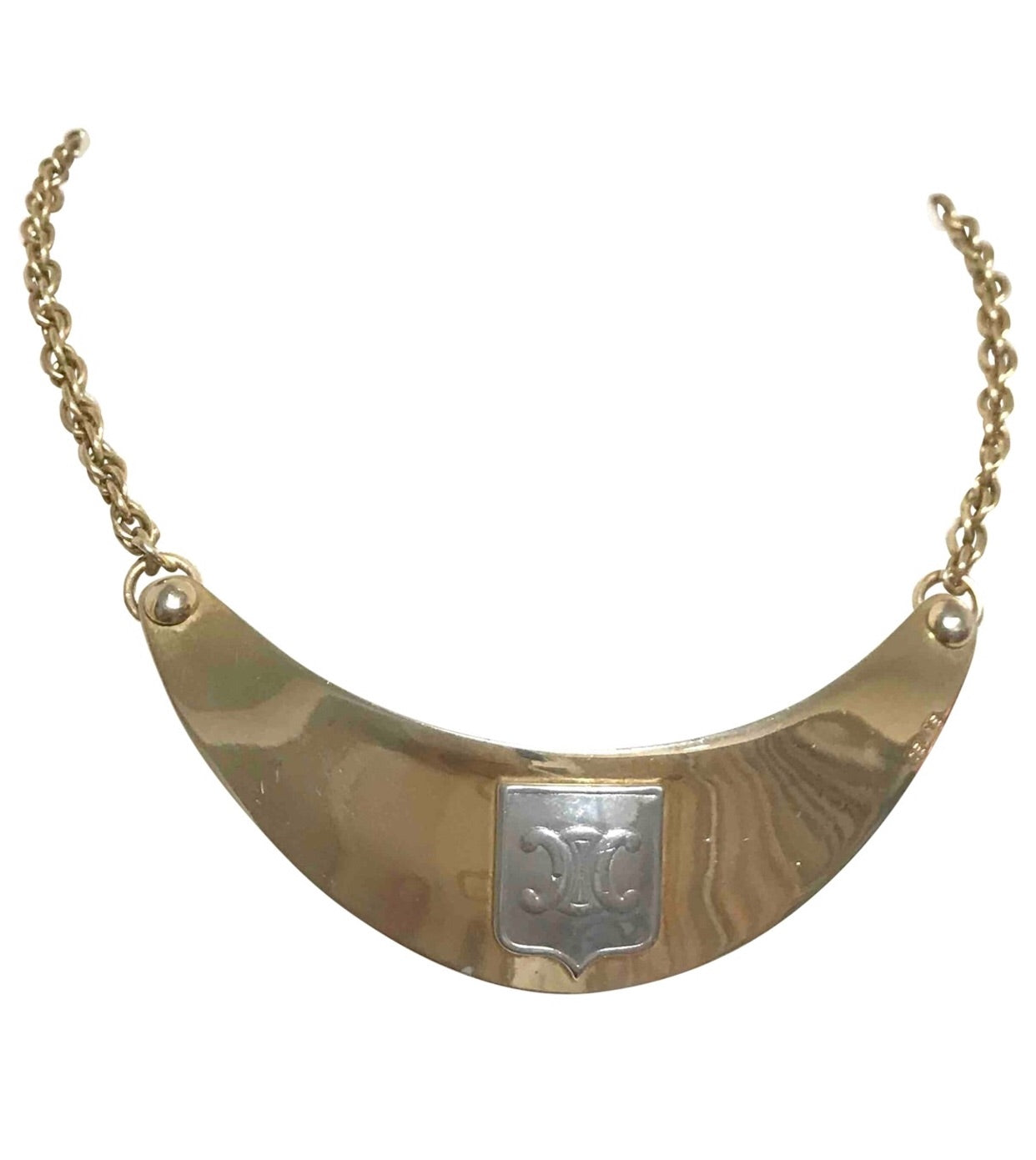Vintage Celine gold tone crescent moon shape necklace with silver triomphe logo. 05062810
