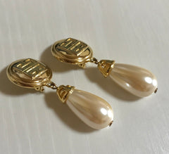 Vintage Givenchy golden round dangle earrings with teardrop faux pearl. Classic and beautiful jewelry piece.