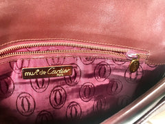 Vintage Cartier wine leather clutch bag with gold tone logo motif. Classic purse from must de Cartier Collection. 060926re8