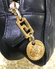 Vintage Gianni Versace black leather purse pouch, case bag with its iconic medusa face and golden logo motif charm. Unisex bag. 061122re1