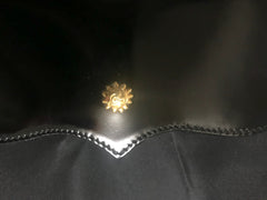 Vintage Christian Lacroix black patent enamel and nylon combo clutch bag with a sun flower shape logo motif.