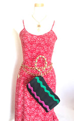 Vintage Moschino by Redwall tube shape black pouch bag with pink, green, and blue wave trimming and gold tone ball design handle. Rare, chic and mod pouch bag.