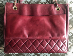 Vintage CHANEL wine leather tote bag with gold chain handles and CC motif charm. Classic purse.