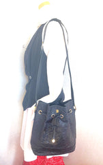 80's vintage BALLY genuine black ostrich leather hobo bucket shoulder bag with golden B logo and drawstrings.
