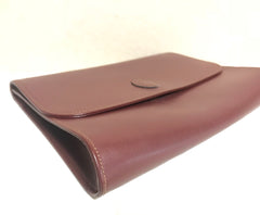 Vintage Cartier wine leather clutch bag, mini document purse with logo motif. Unisex bag from must de Cartier Collection.