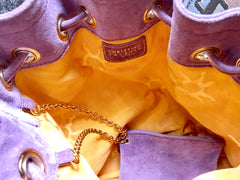 Vintage Christian Lacroix purple suede leather hobo bucket shoulder bag with drawstrings and golden sun, heart etc.. motifs. Unique and chic.