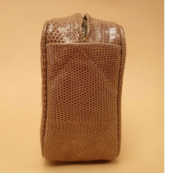 CÉLINE, a brown coated monogram canvas clutch bag. - Bukowskis