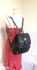 Vintage MCM black leather backpack with golden studded logo motifs. Designed by Michael Cromer. Unisex bag for daily use.