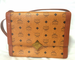 Vintage MCM brown monogram square shoulder bag with leather straps and golden star shape logo motif closure. Designed by Michael Cromer.