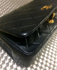 Vintage CHANEL black lambskin mini shoulder bag, classic 2.55 purse with gold tone CC closure.