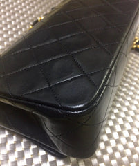 Vintage CHANEL black lambskin mini shoulder bag, classic 2.55 purse with gold tone CC closure.