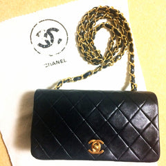 Vintage CHANEL black lambskin mini shoulder bag, classic 2.55 purse with gold tone CC closure.