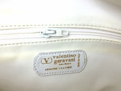 Vintage Valentino Garavani pink leather round shape shoulder purse with white small flower embroideries all over. So chic and cute.