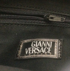 Vintage Gianni Versace black leather backpack with a big embossed medusa with gold tone hardware. Unisex bag for daily use.