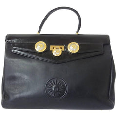 Vintage Gianni Versace genuine black leather Kelly style bag with Medallion Sunburst charms . Gorgeous masterpiece