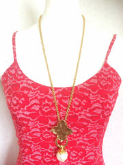 MINT. Vintage Yves Saint Laurent golden chain long statement necklace with extra large faux pearl and flower petal pendant top. Opal shine