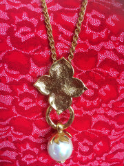 MINT. Vintage Yves Saint Laurent golden chain long statement necklace with extra large faux pearl and flower petal pendant top. Opal shine