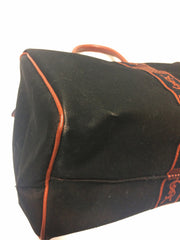 Vintage Yves Saint Laurent black canvas duffle handbag, mini travel bag with brown trimmings and YSL logo. Unisex purse for daily use.