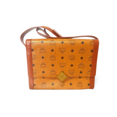 Vintage MCM brown monogram shoulder bag with leather straps and golden star shape logo motif closure. Designed by Michael Cromer. 060621r1