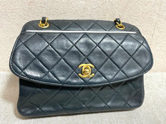 Vintage Chanel dark navy lambskin leather oval shape 2.55 chain shoulder bag with white pipings and CC closure. Rare purse. 061126ac3