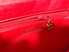 Vintage CHANEL red caviar leather waist bag, fanny pack purse with a matching leather belt and logo charm pull. 26” thru 28”. 070819ac2