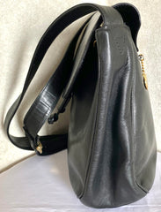 Vintage Moschino black leather shoulder bag with golden cute dangling charms. Heart, safety pin, trumpet, sacks, and guitar. 050725
