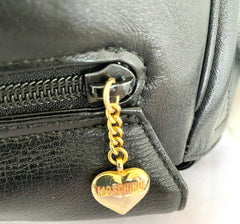 Vintage Moschino black leather shoulder bag with golden cute dangling charms. Heart, safety pin, trumpet, sacks, and guitar. 050725