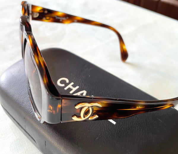 Vintage CHANEL black oval frame sunglasses with golden CC motifs