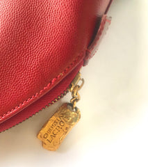 Vintage Christian Lacroix red patent enamel and leather bolide bag with golden logo zipper charm. Comes with shoulder strap. 0403172