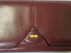 Vintage Bally wine leather clutch bag, party and classic purse with gold tone logo motif.