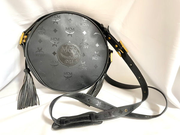 Vintage MCM black monogram rare round shape shoulder bag with black leather  trimmings and fringes. unisex use. Suzy Wong. 0409061