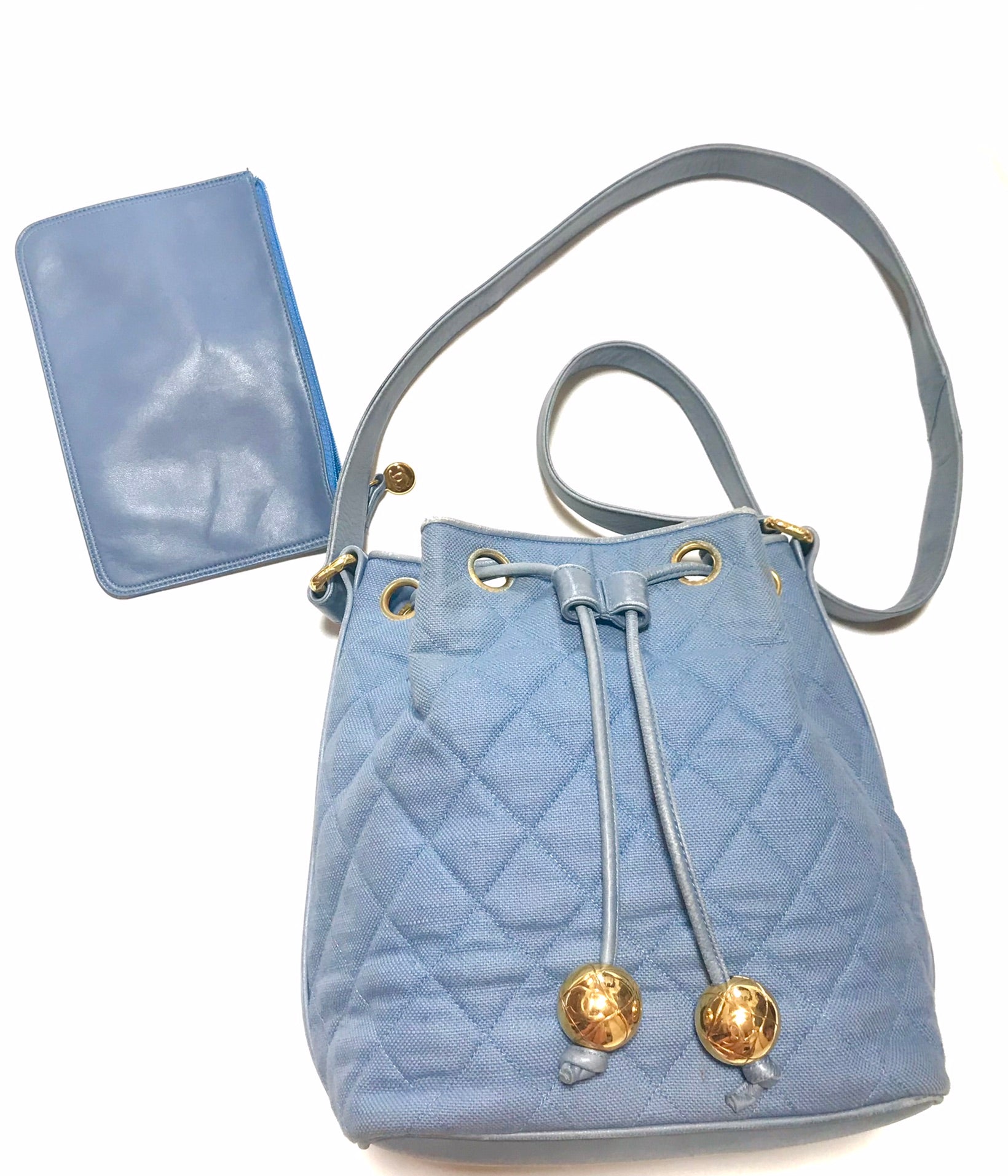 Vintage CHANEL blue quilted canvas and leather combo hobo bucket shoulder bag with drawstrings and golden CC mark balls.