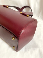 Vintage Cartier classic wine, bordeaux leather handbag purse with bullet design gold hardware at handles. Must de Cartier. 0408171
