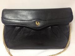 Vintage Christian Dior Vintage black leather clutch purse, mini bag, with golden Dior motif and gold tone chains.