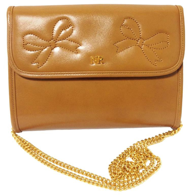 W3. Vintage Nina Ricci tanned brown leather mini clutch shoulder bag with golden chain and ribbon motif stitch marks. 050327re5