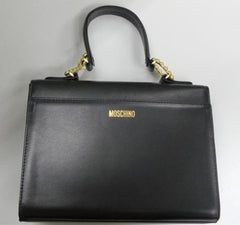Vintage MOSCHINO black leather handbag in classic kelly purse style with golden studded heart, X, and O, playful motifs. Perfect daily bag