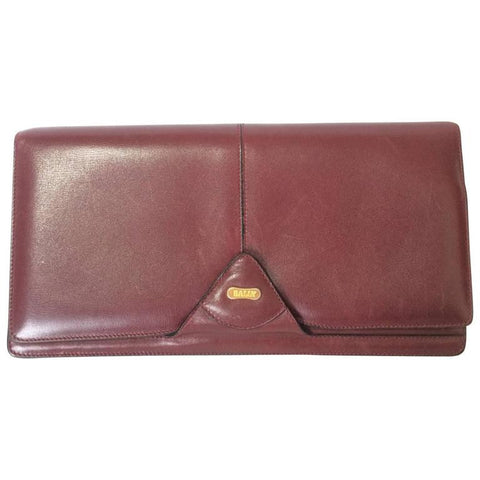 Vintage Bally wine leather clutch bag, party and classic purse with gold tone logo motif.