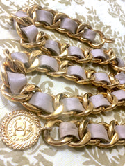 80's Vintage CHANEL beige leather thick chain belt with golden CC and mademoiselle charm. Nice and heavy single layer belt from CHANEL.