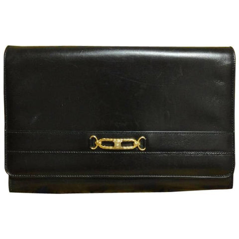 Vintage Celine black calfskin leather clutch purse with iconic golden blason macadam charm at front. riri zipper
