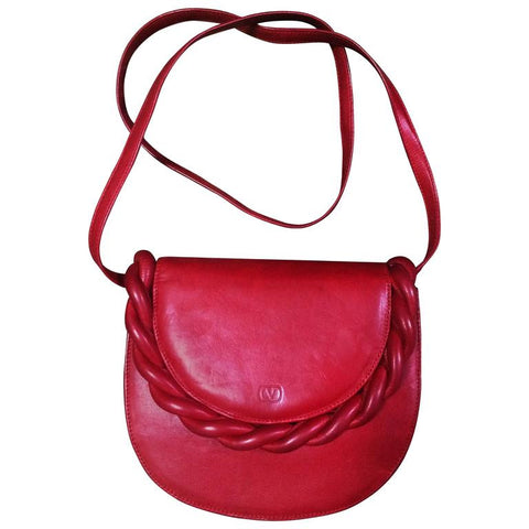 Vintage Valentino Garavani deep cherry red leather shoulder bag with twist motif and V embossed logo.