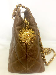 Vintage CHANEL cocoa brown caviar leather chain shoulder bag with golden sun flower CC mark charm. Classic bag