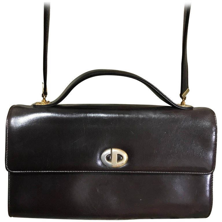 Vintage Christian Dior dark brown leather shoulder bag with silver and golden CD logo motif with a matching kiss lock coin case.